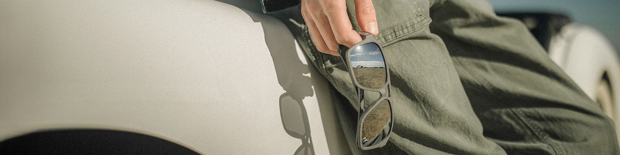 Saunt sunglasses resting on a car dashboard
